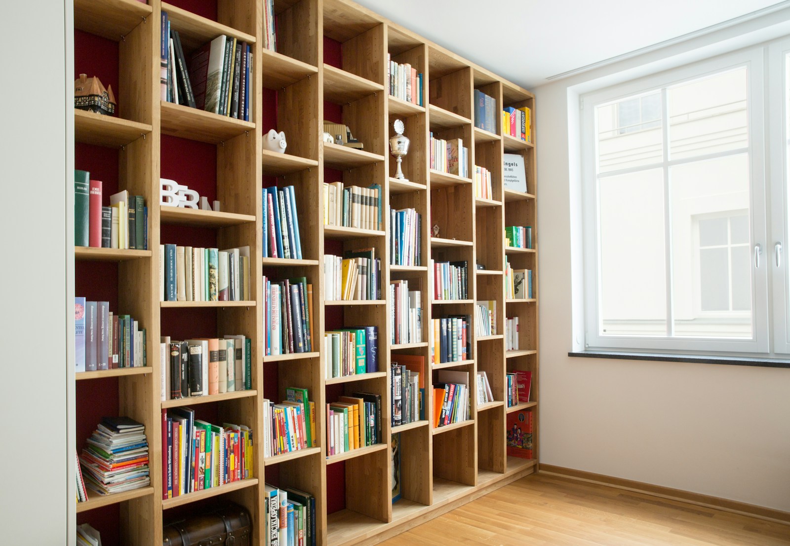 Books and personal objects collected on warm wooden shelves